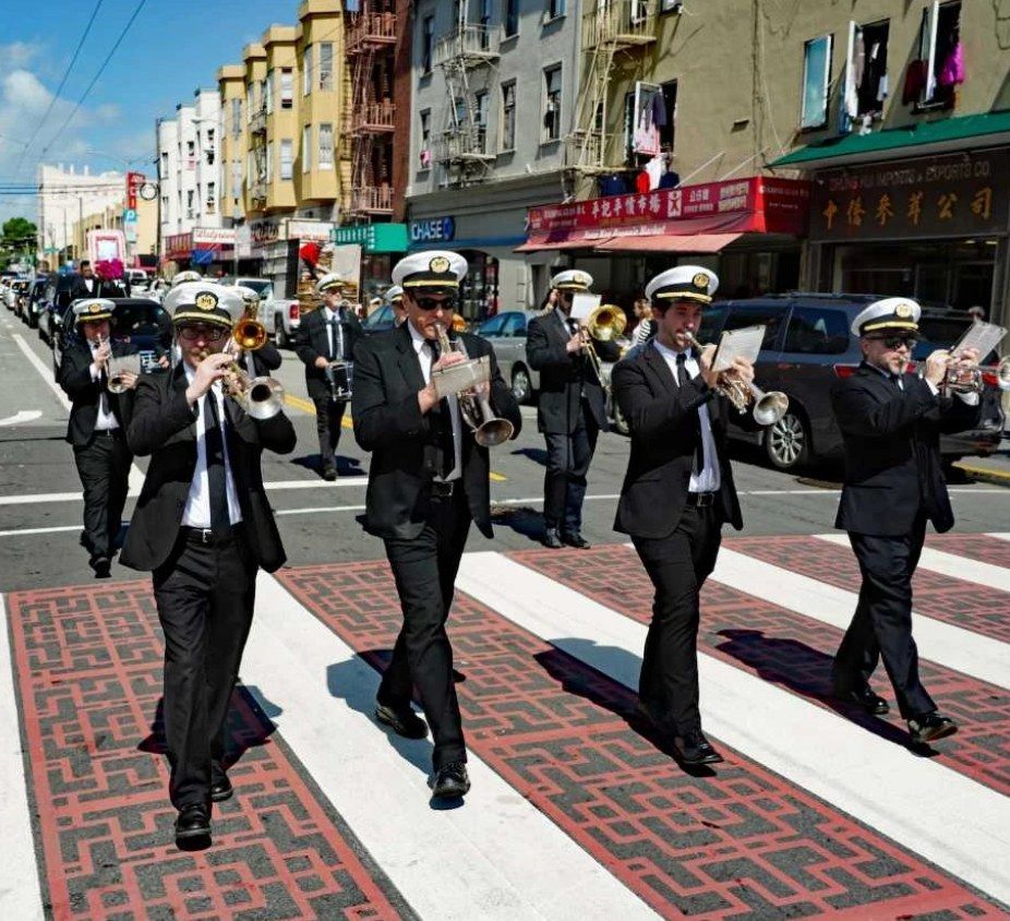 Green Street Memorial Band (formerly Green Street Mortuary Band) performing during a traditional Chinese and Vietnamese funeral procession through San Francisco's Chinatown district with cultural signage visible