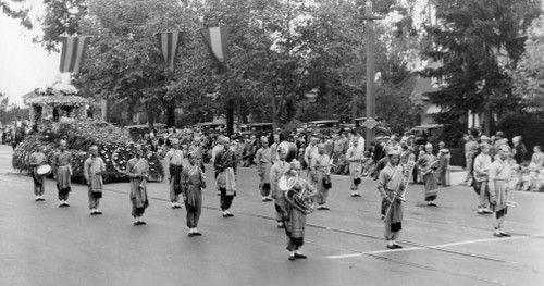 Historical photograph showing an early 20th century Asian funeral procession with a traditional marching band incorporating both Chinese and Vietnamese cultural elements - predecessor to the Green Street Memorial Band (formerly Green Street Mortuary Band)