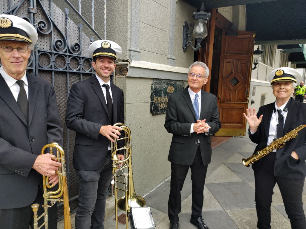 Band members with their instruments standing outside the Green Street Memorial (formerly Green Street Mortuary) location, ready to perform for a Chinese or Vietnamese funeral ceremony